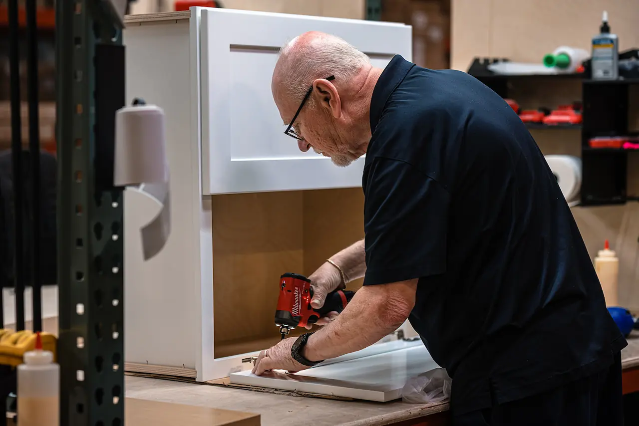 Craftsman assembling a cabinet for a Macedonia Ohio kitchen order