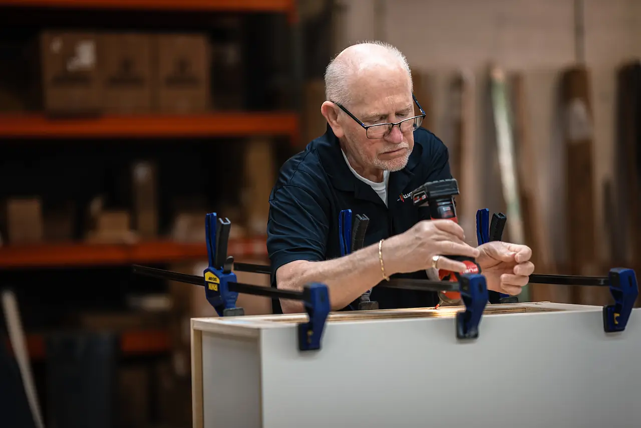 Craftsman using clamps during cabinet assembly for a Fairlawn Ohio order