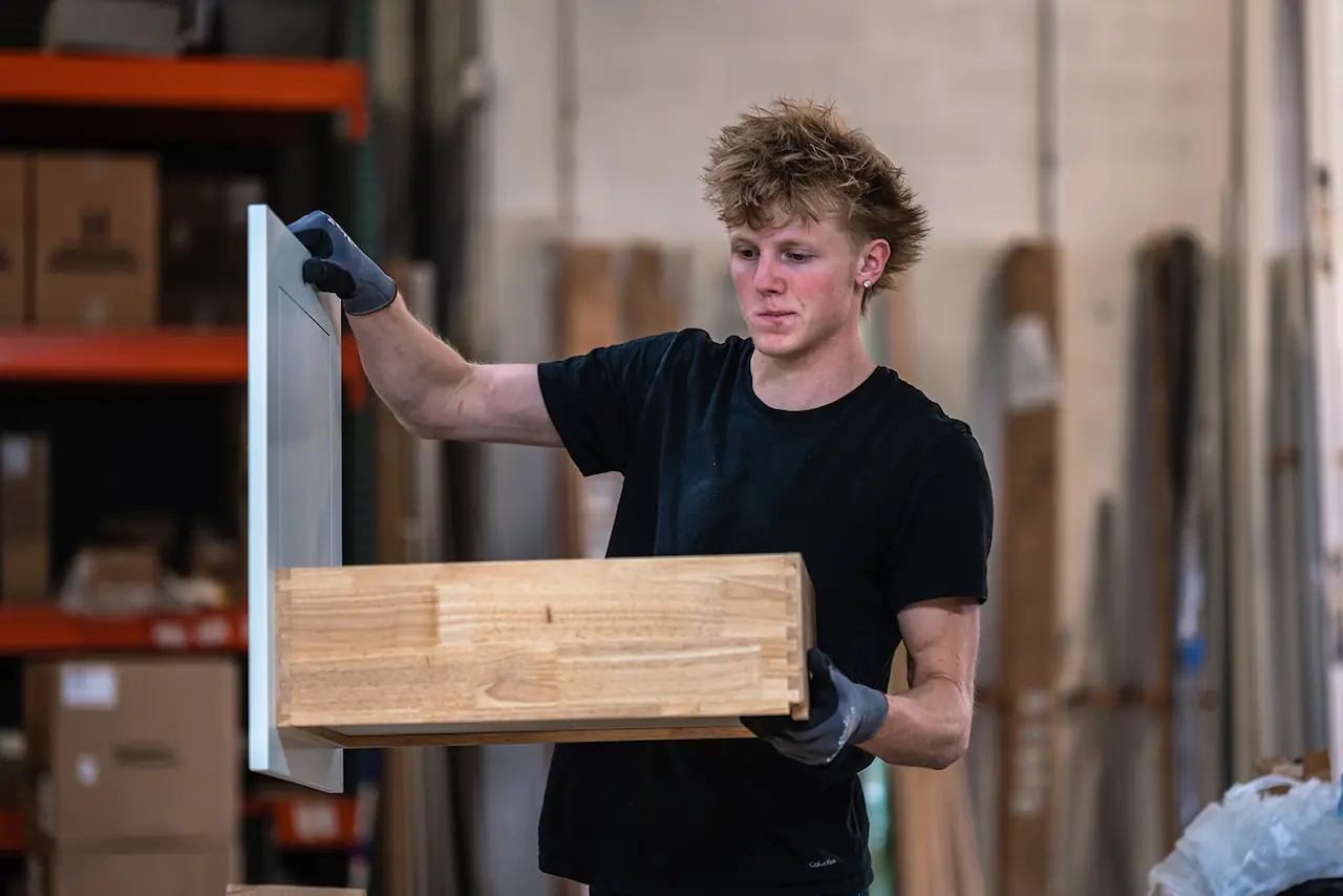 Warehouse worker carrying a cabinet drawer for a North Ridgeville Ohio order