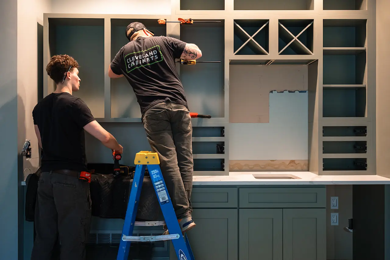 Workers installing kitchen cabinets in a North Ridgeville Ohio home
