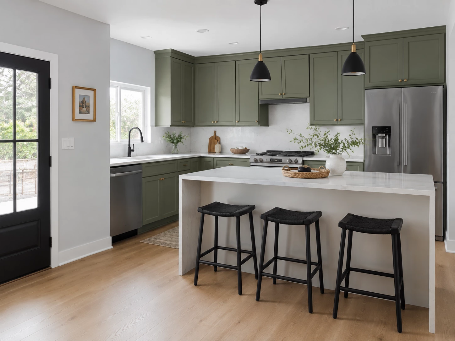Bevel Green cabinets in a contemporary kitchen with a quartz peninsula and black accents