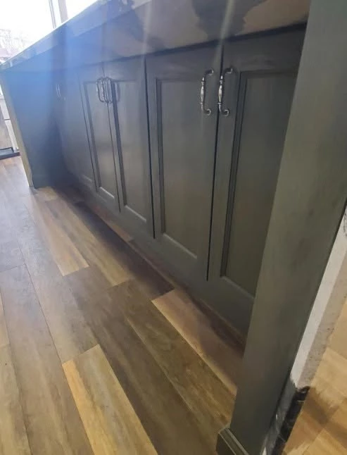 Charcoal gray kitchen island with waterfall countertop and bar stool seating at the Cleveland showroom
